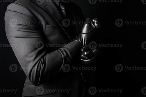 Portrait of Strong Man in Dark Suit Pulling on Black Leather Gloves ...