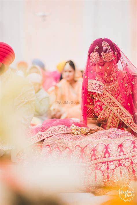 Photo of Sikh bride with veil in red lehenga