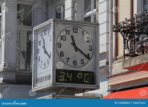 Square Clock in a Public Space Indicating Time and Temperature. Stock ...