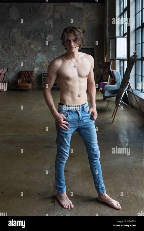 Handsome blond male model with blue eyes full body posing indoors Stock Photo - Alamy