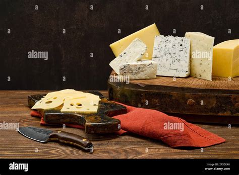 Assortment of different types of cheese on wooden block Stock Photo - Alamy