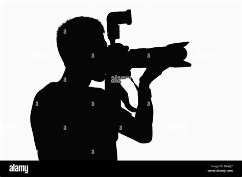 Silhouette of man holding camera Stock Photo - Alamy