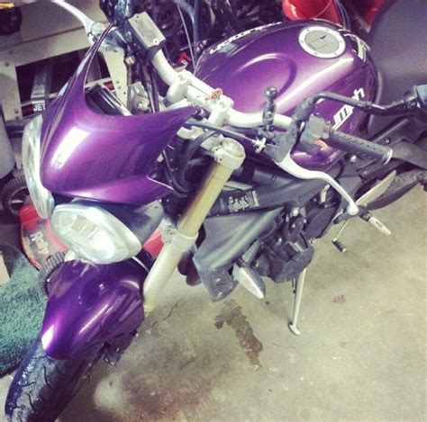 a purple motorcycle is parked in a garage