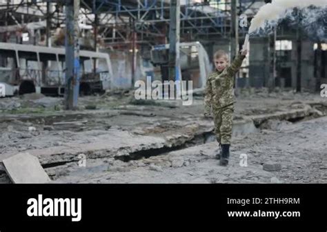 Boy Soldier Wearing Military Uniform Holding a White Smoke Bomb in the Hand Walking in the ...