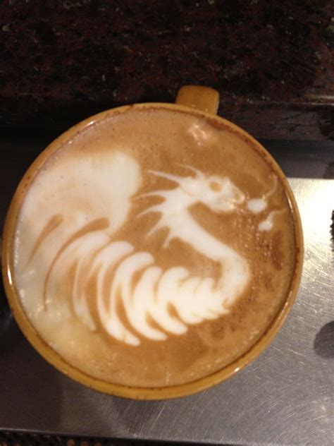 a cappuccino with a dragon drawn on it