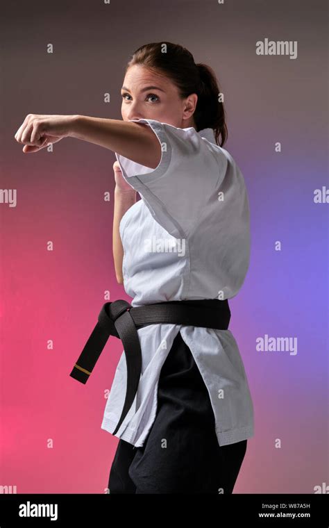 Athletic woman in traditional kimono is practicing karate in studio Stock Photo - Alamy