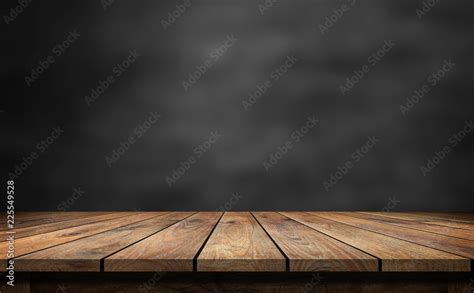 Wooden table with dark blurred background. Stock Photo | Adobe Stock