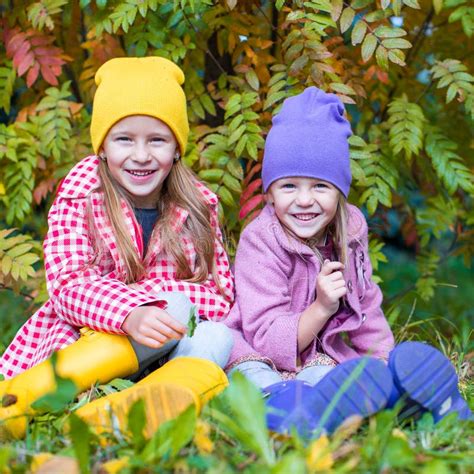 Two Adorable Girls in Forest at Warm Sunny Autumn Stock Photo - Image of outdoor, leaves: 45740890