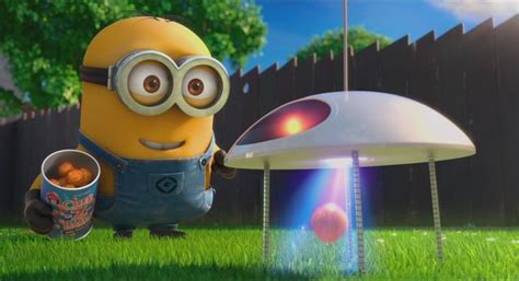 a minion holding a cup next to an object in the grass with trees and ...