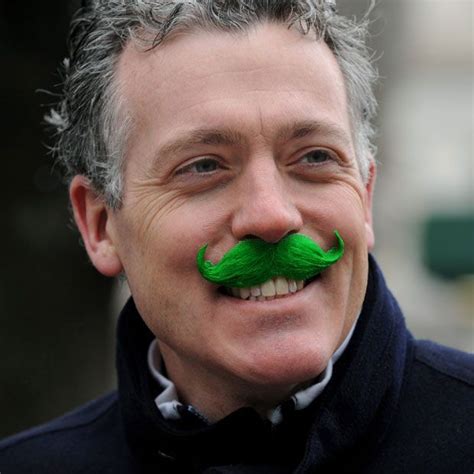 A man with a green moustache watches the 251st annual Saint Patrick's ...