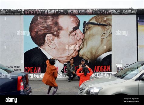 A painting of Gorbachev and Honecker kissing on the Berlin wall Stock ...