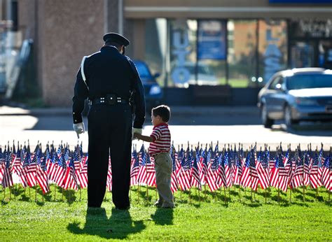 An Honor Guard Officer explains the meaning of the flags to a young boy. | Honor guard, Police ...