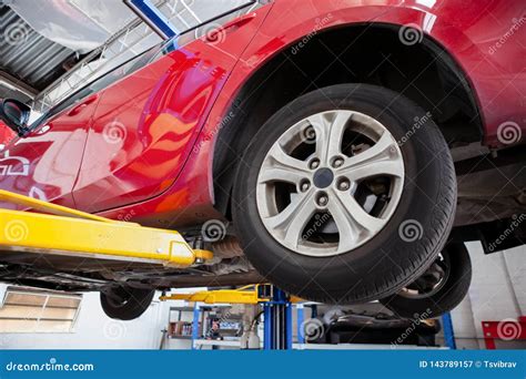 Vehicle Lifted On Hydraulic Car Lift. Royalty-Free Stock Photo | CartoonDealer.com #143789157