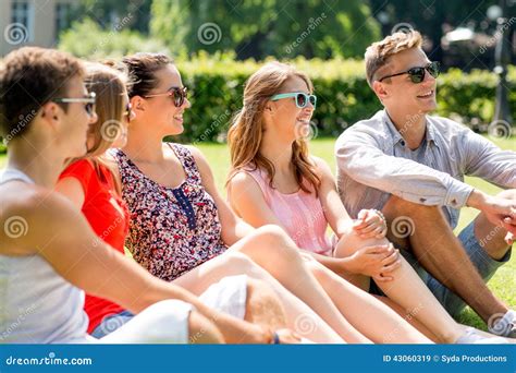 Group Of Smiling Friends Outdoors Sitting On Grass Stock Photo - Image: 43060319