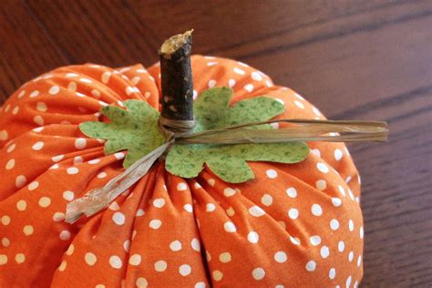 an orange and white polka dot pumpkin sitting on top of a wooden table