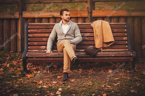 Handsome young man sitting on the bench — Stock Photo © jozzeppe #89985980