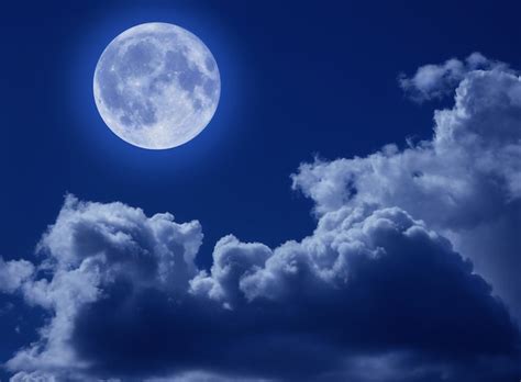 Premium Photo | A full moon in a tragic night sky with clouds. A ...