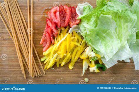 Spaghetti, Tomato, Bell Pepper and Crisphead Lettuce on Wooden Chopping ...