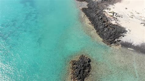 Aerial view of a crystal blue ocean - Free Stock Video