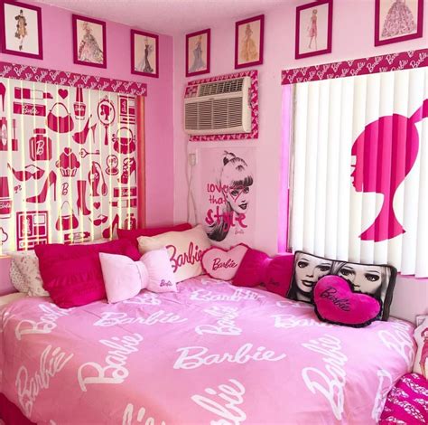 a bedroom decorated in pink and white with pictures on the wall