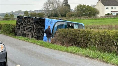 Double-decker bus overturns into field near Stanley - BBC News