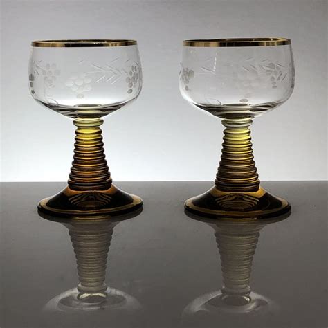 Two German wine glasses, 4 ounce, amber beehive stem, white etched grapevine and gold trim ...