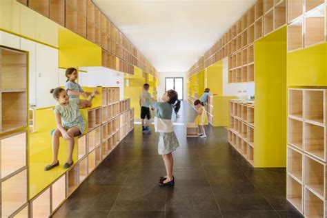 Walls with integrated furniture and yellow nooks encourage play in Madrid school Modern Living ...