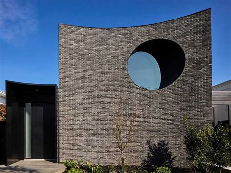 Curved brick facade, monochromatic palette deliver engaging urban ...