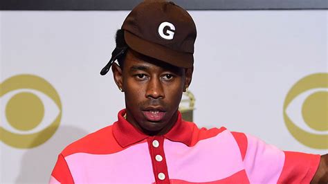 Tyler The Creator Is Wearing Light Pink Red Striped Dress And Brown Cap ...