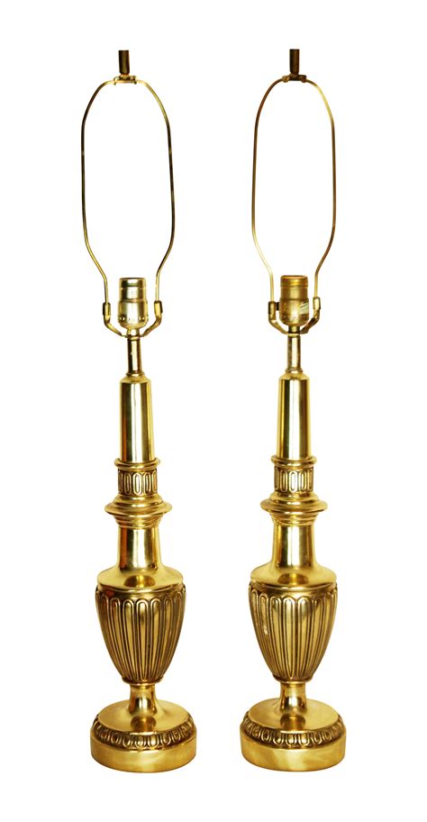 Classically elegant pair of mid century heavy solid brass lamps. These lamps are in excellent ...