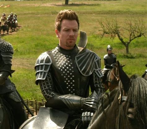 a group of men riding on the backs of horses next to each other in armor