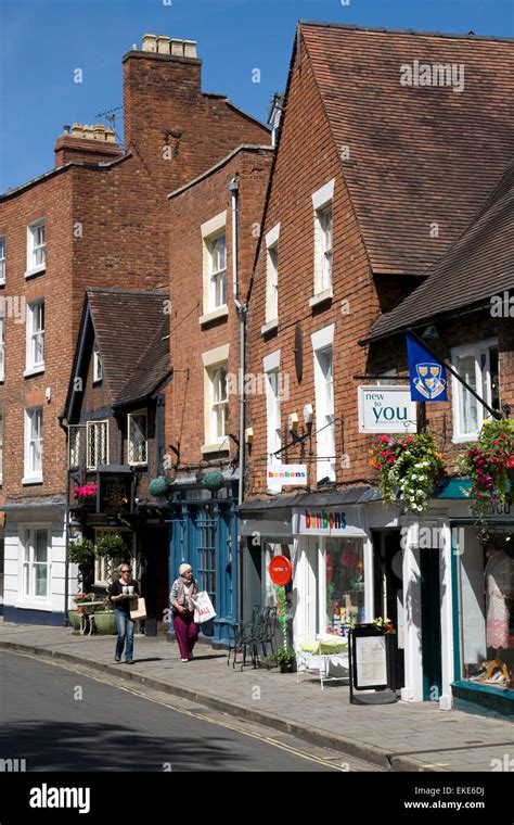 Shrewsbury town centre. Two shoppers walk past attractive shops on a Stock Photo, Royalty Free ...