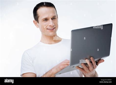 Positive smart man looking at the laptop screen Stock Photo - Alamy