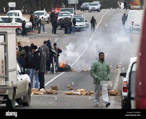 SIDI BOUZID, Tunisia - Young men burn tires and blockade a road in the suburbs of Sidi Bouzid ...