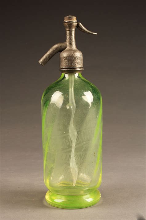 Antique French green seltzer water bottle with etched design.