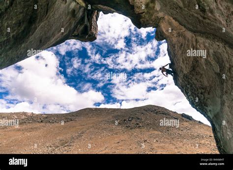 Man rock climbing an overhanging cliff in hatun machay hi-res stock ...