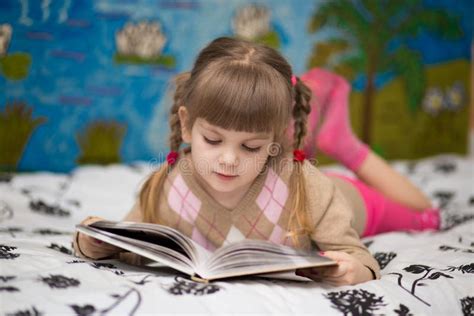 Little Cheerful Girl Read Book in Bed Stock Photo - Image of ...