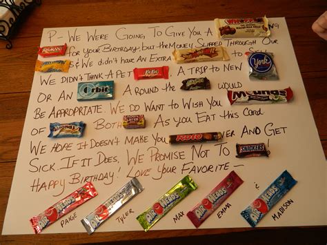 a sign that has candy on it with writing in front of it and some candies