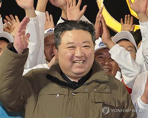 North Korean leader Kim Jong-un cheers after a new type of Chollima-1 rocket carrying a ...