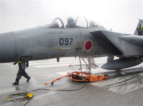 "The front wheel fell off." Japanese F-15J sits on a runway after its forward landing gear fell ...