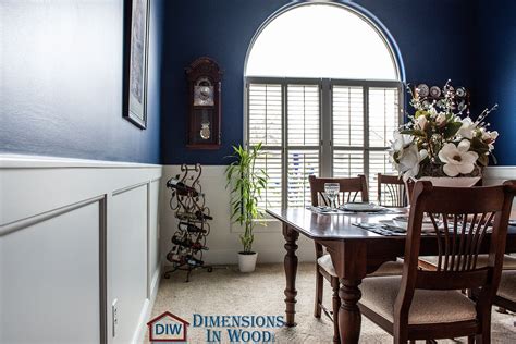 Custom White Wainscoting in Bold, Blue Formal Dining Room