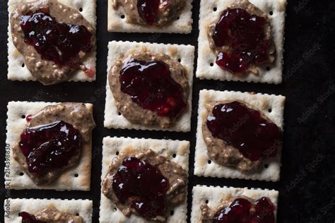 Peanut butter and jelly on crackers Stock Photo | Adobe Stock