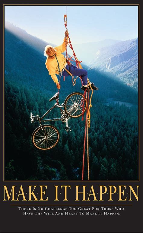 a man on a bicycle hanging from a rope in the air with mountains behind him