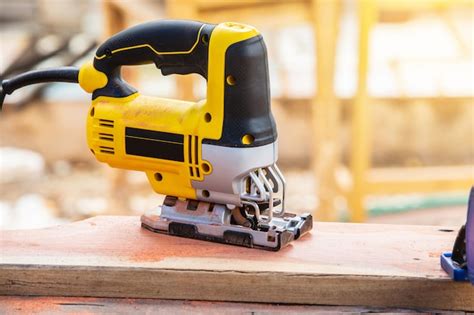 Premium Photo | The yellow jigsaw for wood working.