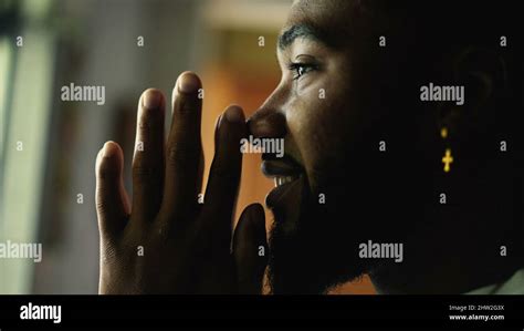 A spiritual black man praying with hands together Stock Photo - Alamy