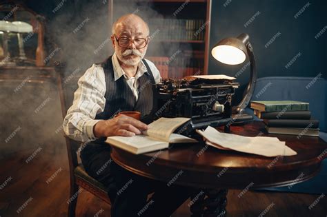 Premium Photo | Elderly writer works on vintage typewriter in his home ...