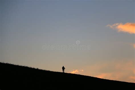 Silhouette of a Man Walking Away in Sunset Stock Photo - Image of silhouette, cloud: 44179528