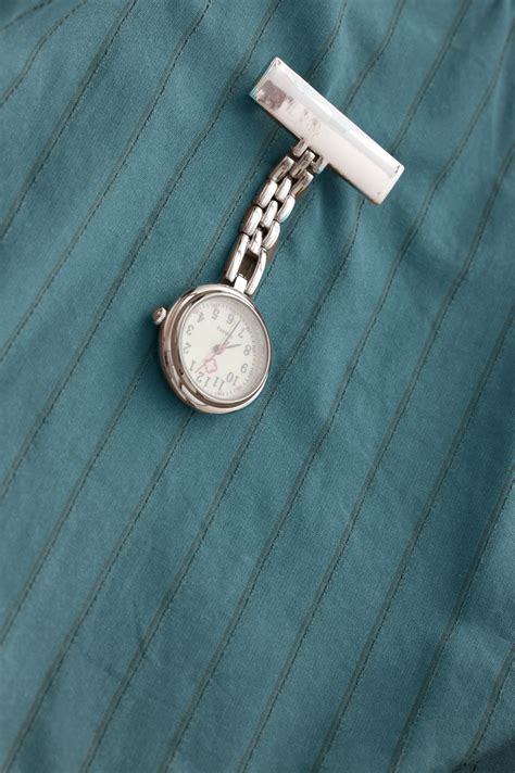 Free Stock Photo 12953 Nurses silver fob watch pinned on a uniform | freeimageslive