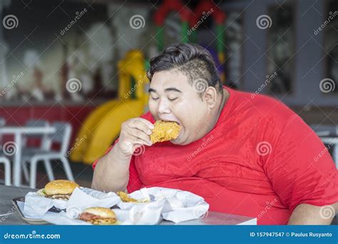 Greedy Obese Man Eating Fast Foods In Restaurant Royalty-Free Stock ...