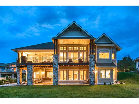 Stunning rear exterior view of luxury Craftsman style home plan | Craftsman house plan ...